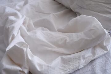 Bed linen texture. White bed linen background. Bed. Interior.