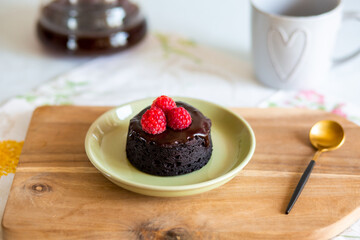 chocolate fondant cake. Mini cake for fondant with icing. Delicious  dessert.Homemade chocolate lava cake.
Fondant Lava Cupcake.Warm chocolate dessert.Chocolate cake.Cupcake with berries.Sweet.