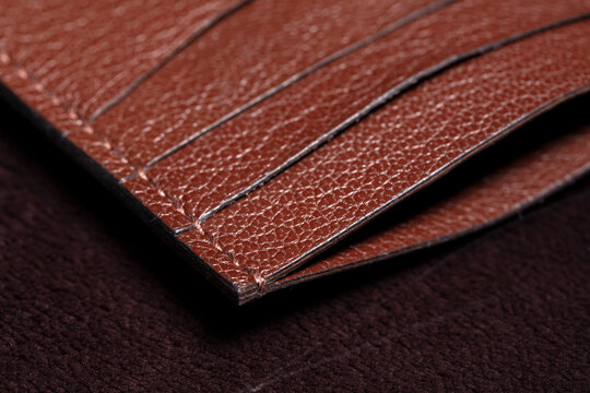 Part of a brown leather wallet or purse close-up.