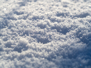 The texture of the snow and bokeh in bright sunlight