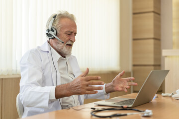 Senior old doctor wears headset. Remote online medical chat consultation, tele medicine distance...