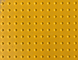 yellow tactile crosswalk sidewalk intersection pavement  rumble nonslip surface for waiting to cross the road