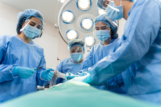 Medical Team Performing Surgical Operation in hospital operating. Medical team doing critical operation.