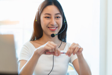 asian cheerful contact center talking with client to help solve problem with smart and smiley face.