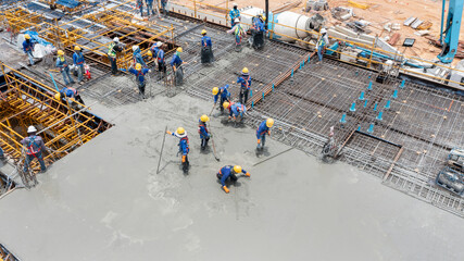 construction worker pouring concrete by pumping
