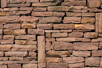 wall of natural red large stones. background. Copy space