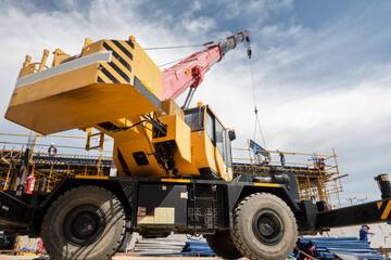 Obraz na płótnie Canvas A mobile crane working at construction site