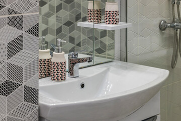 A modern bathroom sink in a modern residential building or hotel. Modern white sink in the bathroom...