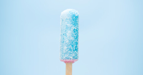 Close-up detail - Popsicle stick jelly blue isolated on the blue background.