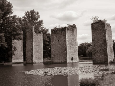 view of the ruins of the old bridge at Lussac Les Chateau in France in black and white