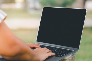 women using laptop or notebook computer with blank copy space screen, confident woman working with blank screen computer laptop concept, contact business search information in garden concetual.