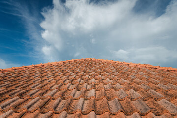 Close up of brown clay roof tiles. Red old dirty roof. Old roof tiles. Construction equipment build a house.