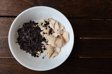 Overhead view of crushed egg shell and spent coffee grounds in bowl. Natural organic fertilizers for gardening rich in nitrogen, calcium and potassium
