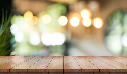 Empty wooden table top with lights bokeh on blur restaurant background.