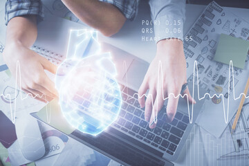 Double exposure of man and woman working together and heart hologram drawing. Computer background. Top View.