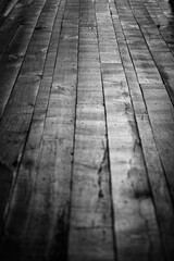 Black and white image of an old wood floor, shot with shallow depth of field.