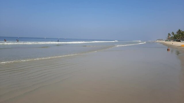 Turquoise water and white sand in beautiful Colva beach, clean water Arabian sea beach, goa beach, tropical beach.