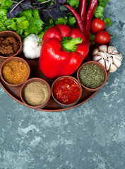Georgian spices in clay jars on a plate.
