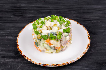 olivier salad with beef, potatoes, carrots, salted cucumber, egg, green peas, mayonnaise