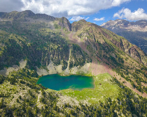 Aerial view of a wild lake in the middle of the high mountains of pyrenees.