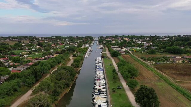 Aerial view of a canal harbor with moored boats and rafts. Foce Sisto.
Aerial drone shot of boats moored in the Sisto river in San Felice Circeo, Lazio, Italy.