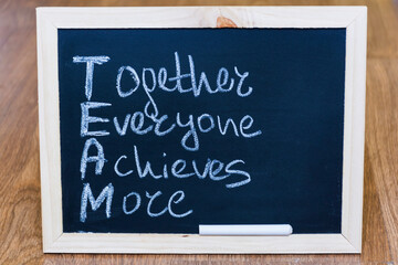 Team Concept with Chalk Board and Together Everyone Achieves More Text 