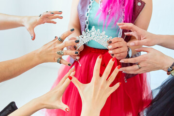 The girls ' hands reach for the crown. Who will be the Queen, the boss or the first beauty. The concept of competition and competition.