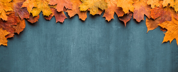 Autumn maple leaves on ancient texture. Falling leaves natural background. Seasonal background.