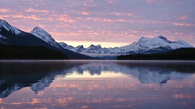 Sunrise over Canadian rockies reflection on Maligne lake at Jasper national park