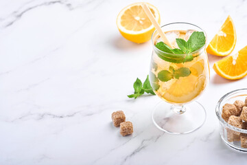 Traditional iced tea with lemon and ice in tall glasses on marble table background Iced tea with lemon. Selective focus. Refreshment cold summer drink.