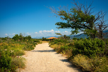 Beautiful trekking trail across the mountain valley to Biserujka cave on Croatia island Krk