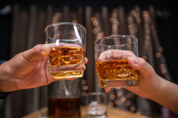 Celebrate whiskey on a friendly party in restaurant.