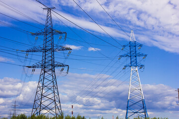 high voltage power lines against the background of the summer sky with clouds