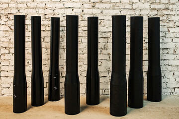 black cylindrical plastic pipes of different diameters are in stock. exhibition samples of the products of the pipe rolling plant. polymer pipes for laying underground utilities