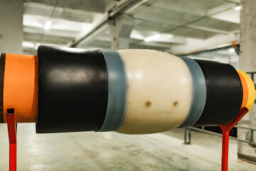 large diameter polyurethane pipe. modern stainless steel pipes with thermal insulation. a demonstration sample of the pipe stands on metal stands