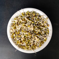 Green sprouted moong in a plate. Mung bean sprouts are a culinary vegetable grown by sprouting mung beans. Mung Bean Sprout