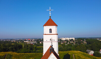 Fototapeta na wymiar Aerial view of the cross on the tower. Medieval European church with Romanesque architecture