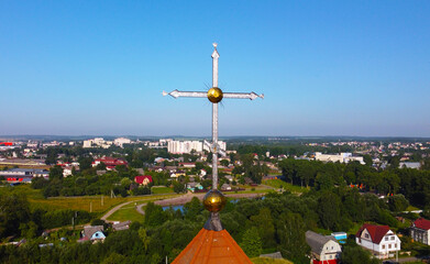 Fototapeta na wymiar Aerial view of big golden church cross on church