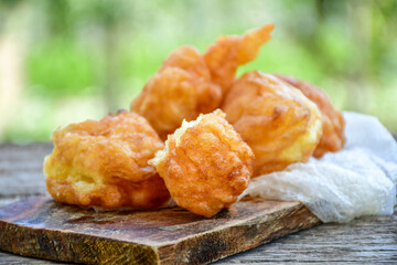 Traditional Bulgarian home made deep fried  patties  covered with sugar  оn rustic backgroud.Mekitsa or Mekica,  on wooden  rustic  background. Made of kneaded dough that is deep fried 