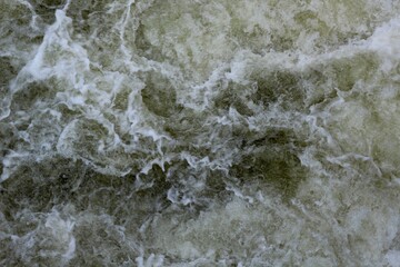 The fast moving rapids from the creek water.