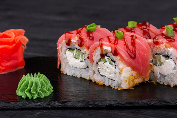 Rolls with tuna, curd cheese, tuna, cucumber, green onion, white sesame, spice sauce