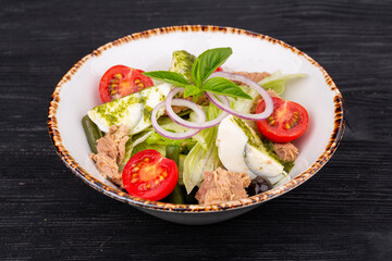Salad with canned tuna, eggs, tomatoes and lettuce leaves