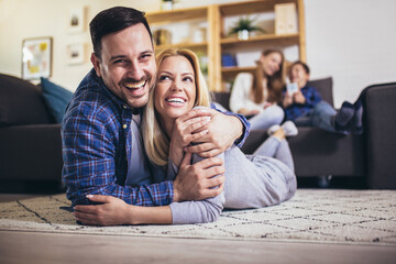 Happy family with kids playing at home.