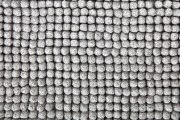 Gray, soft bath mat texture background in natural cotton