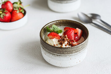 Strawberry, cream cheese and feta cream and crumble crust dessert. Homemade Sweet and salty cheesecake. Trifle. Selective focus