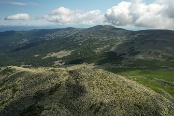 AERIAL: an epic panorama of mountains with thunderclouds. shot of adventure hiking in mountains alone outdoor active lifestyle travel vacations. Conceptual scene