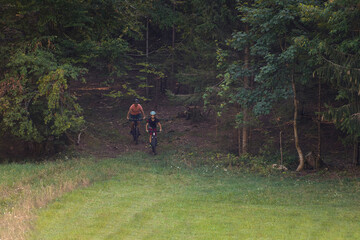 Two girls on mtb bikes. Mother and daughter riding on a trail.