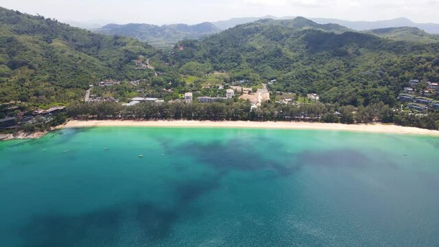 4K Aerial Side View of Nai Thon Beach in Phuket. Beach, sea and sand. Drone view of a beautiful white tropical sand beach on a summer day in Thailand. Top view empty and clean beach. Phuket, Thailand