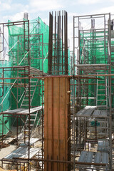 Fototapeta na wymiar PENANG, MALAYSIA -JUNE 3, 2021: Column timber formwork and reinforcement bar at the construction site. Installed by construction workers. The formwork supported by the temporary wood support.