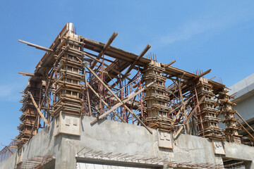 PENANG, MALAYSIA -JUNE 3, 2021: Column timber formwork and reinforcement bar at the construction site. Installed by construction workers. The formwork supported by the temporary wood support.